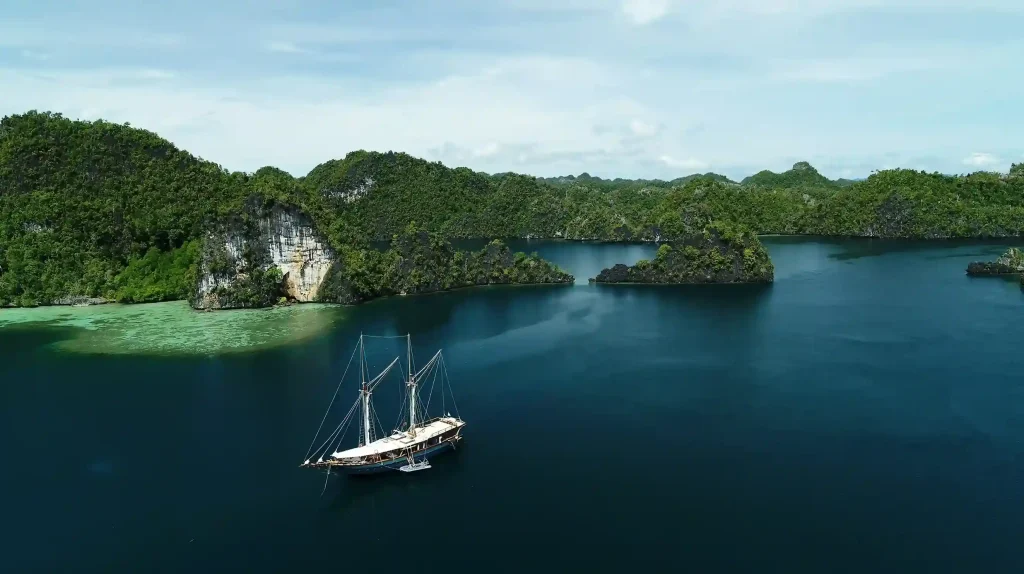 Phinisi anchored among the karst islands at Harfat, Raja Ampat