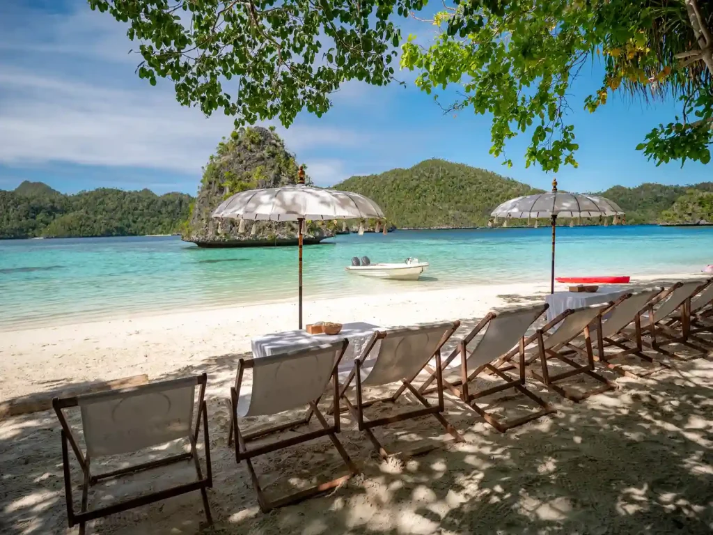 Sun loungers and umbrellas set up on a remote beach