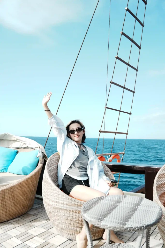Guest relaxing on the shaded deck of a charter yacht