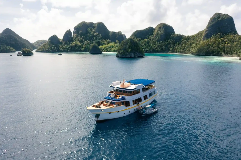 Liveaboard cruising between the karst islands of Raja Ampat