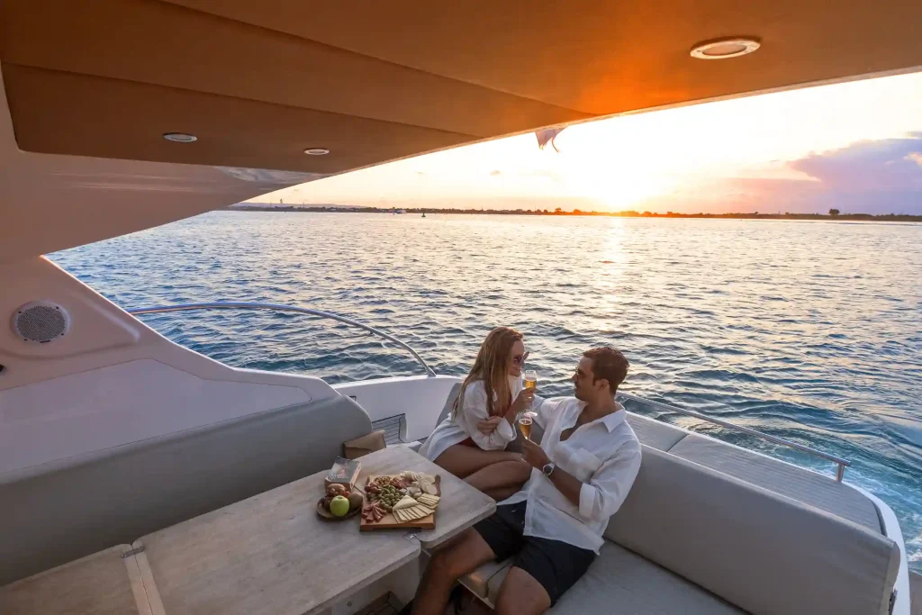 Couple on the deck of a charter yacht at sunset